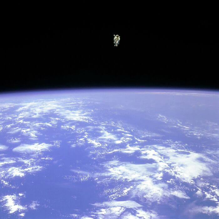 Astronaut Bruce Mccandless Is Floating Away from The Space Shuttle's Safety. He Had Nothing but His Manned Maneuvering Unit Keeping Him from Drifting into The Unknown. First-Person In History to Do Something Like This