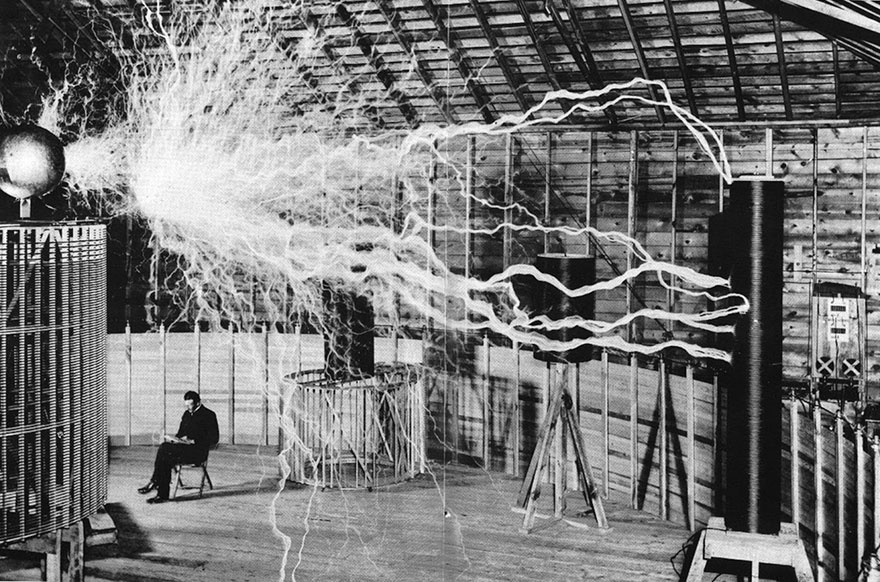 Nikola Tesla, Seated In His Laboratory With His "Magnifying Transmitter"